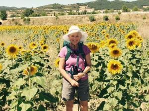 Carolyn Holmes in field of sunflowers